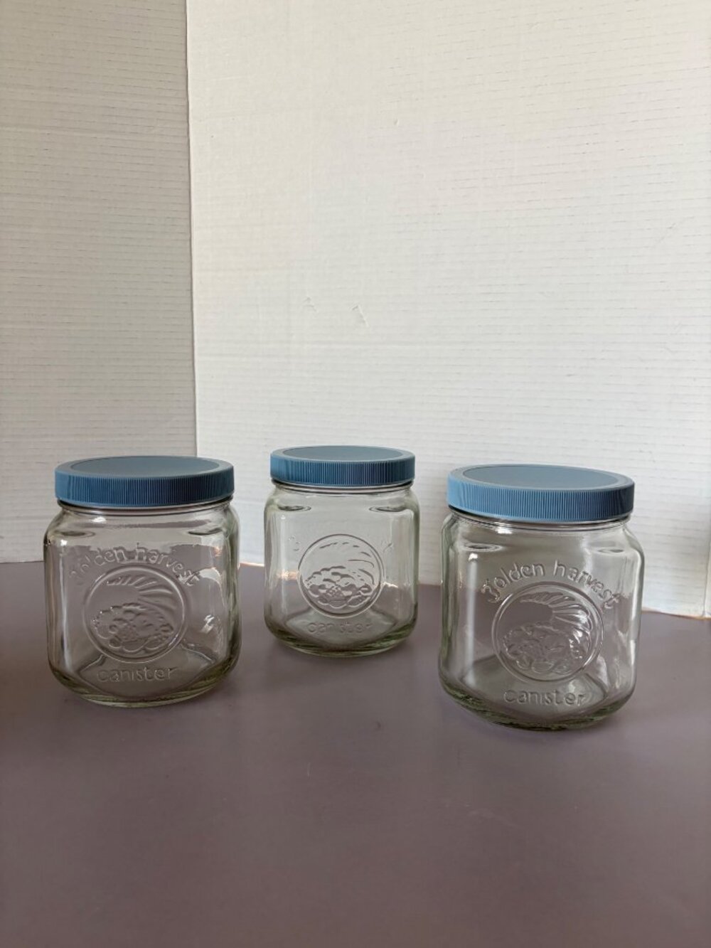 Set Of 3 Golden Harvest Glass Canisters With Blue Plastic Lids